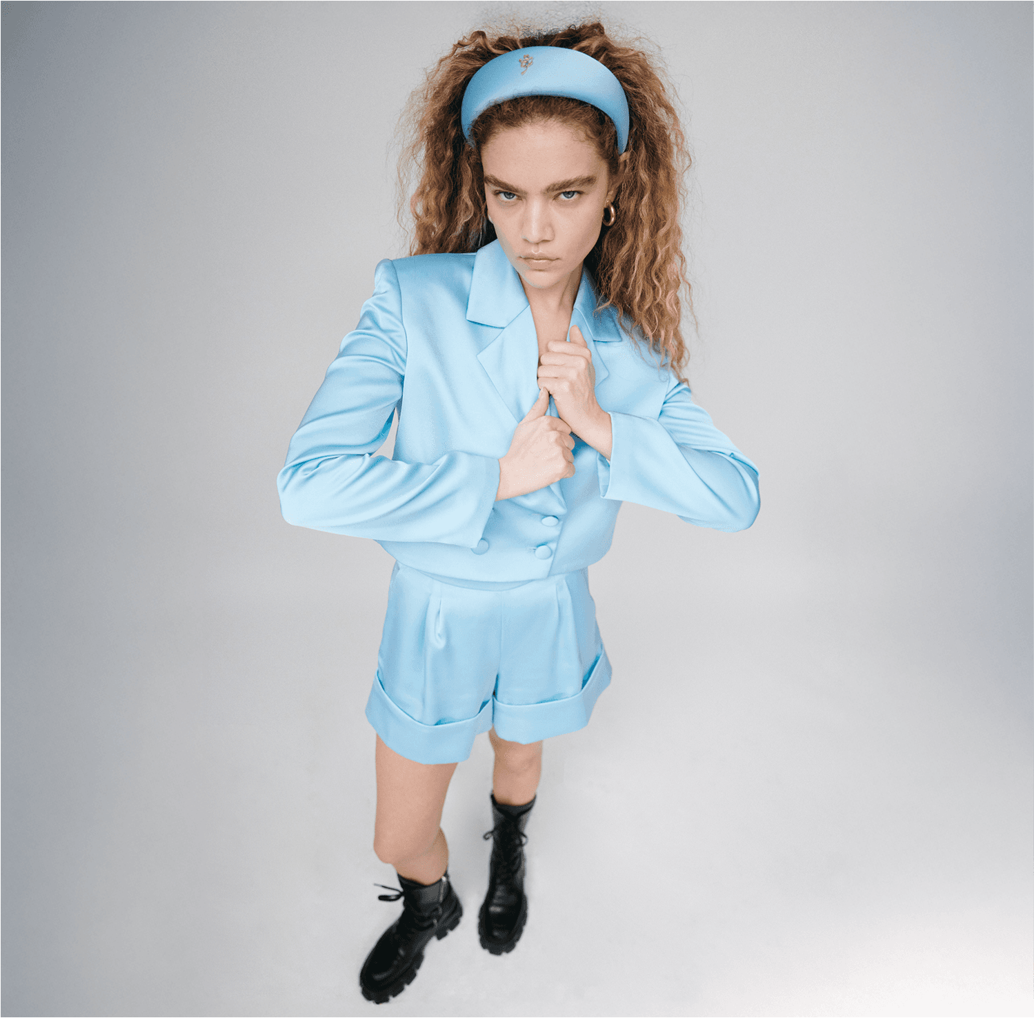 woman in blue blazer matching satin set